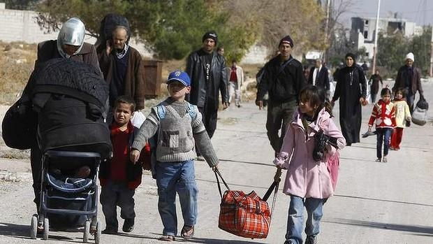 Syrians flee Moadamiya once the regime temporarily breaks the siege and allows people to leave the town