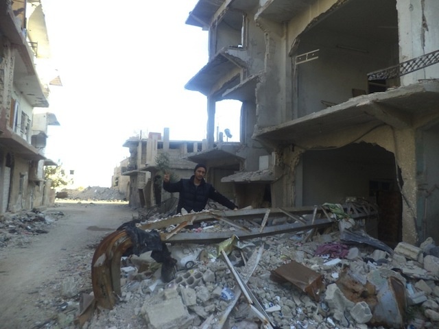 Qusai on the streets of Moadamiya, which has been attacked nearly daily by the regime by shelling and aircraft bombings